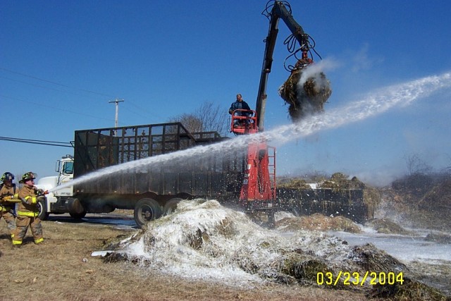 Firefighter Ron Weir on the nozzle at a truck/hay fire on Route 1, March 04