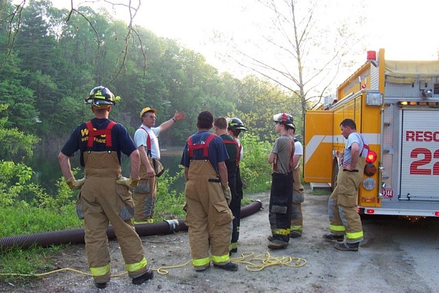 Firefighter Dave Talley explains the fine points of drafting