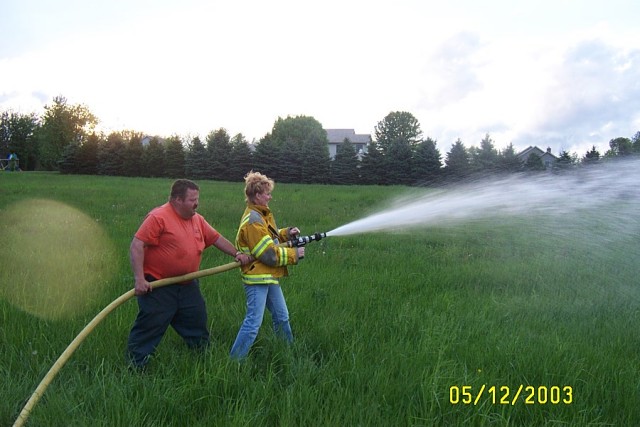 EMT Cyndi Macauley is on the nozzle, Engineer Lary Hicks is the backup