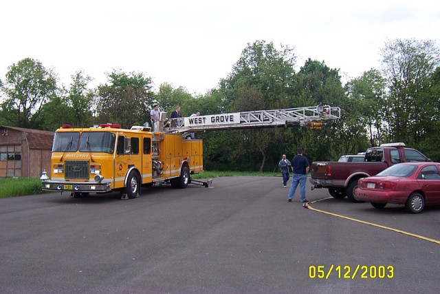Firefighter Mike Predmore attempts to lift his pickup with Ladder 22
