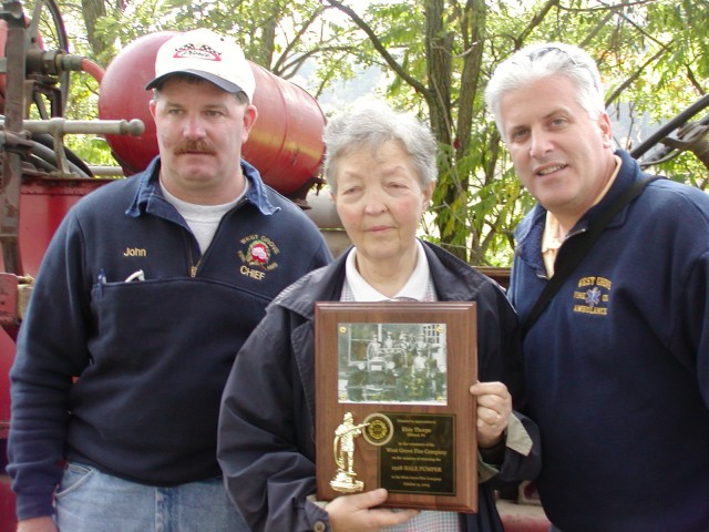 Chief John  Chambers and President Bill Wohl present Elsie Thorpe with a commemorative plaque honoring the return of Antique 22 to the West Grove Fire Company.  Mrs. Thorpe's husband was the owner of the 1927 Hale Pumper.  She contacted the WGFC upon her husband's death, allowing Antique 22 to return to her orginal home after more than 50 years.