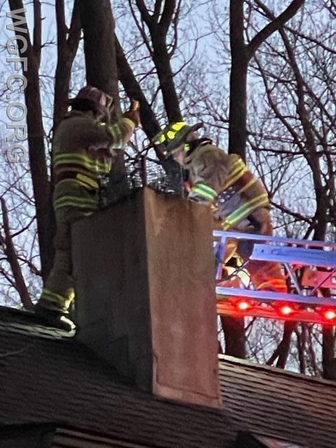WGFC firefighters work to clear an obstructed chimney in Penn Township Friday evening.