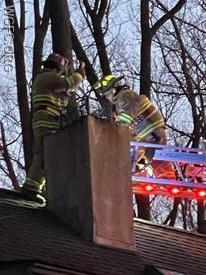WGFC firefighters work to clear an obstructed chimney in Penn Township Friday evening.