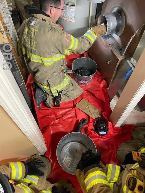 Firefighters had to disassemble piping from the furnace to the chimney to access burning materials.  The red tarps are spread to protect flooring and carpets when WGFC works inside.