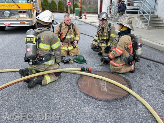 Class students review a training scenario with a class instructor.  WGFC firefighter Will Ginn is second to the right.