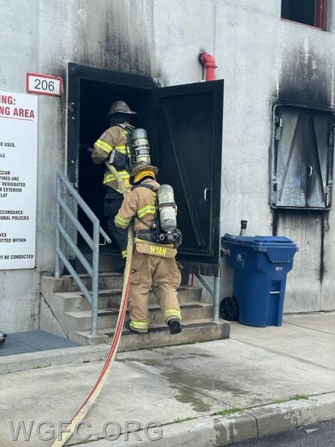 WGFC firefighter John Ryan advances a hose line into the burning building.