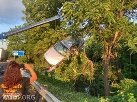 A heavy tow truck cranes a car from off the US 1 Bypass after WGFC handled a complicated rescue Tuesday evening.