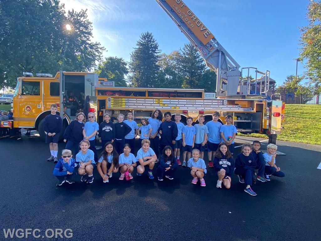 Students at Assumption BVM School pose with Ladder 22 during fire prevention activities.