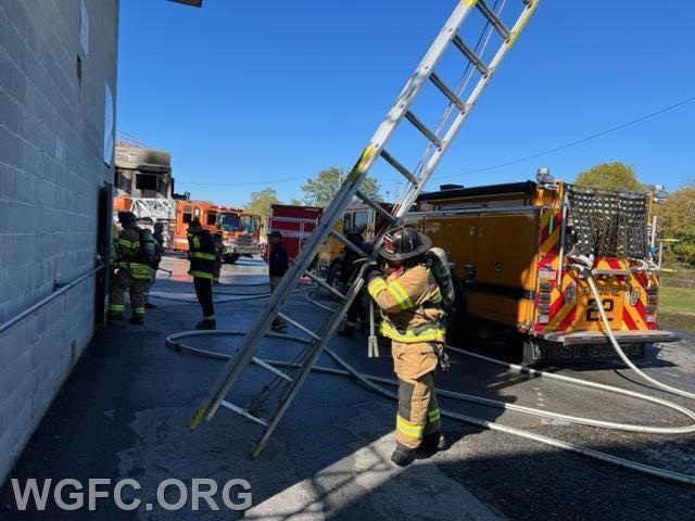Firefighters practice throwing ladders under realistic conditions.