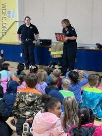 WGFC's Firefighter Lisa talks about calling 911 during fire prevention activities at the AG Charter School.