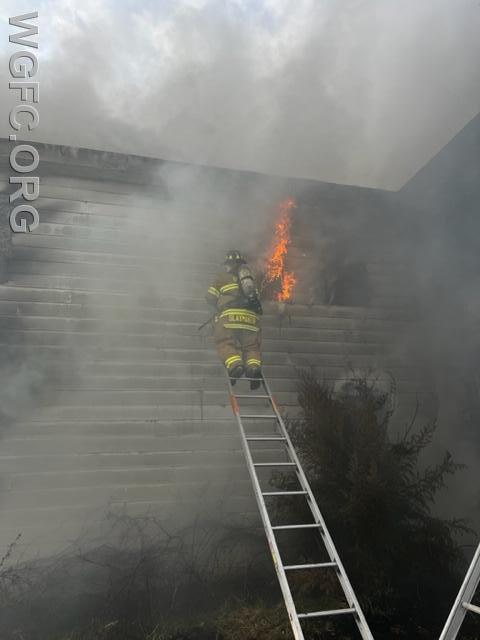 A WGFC firefighter works to extinguish fire on the second floor.