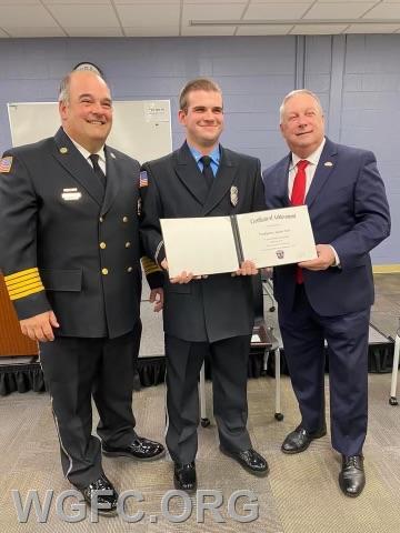 The Chief pushed for the recruitment and retention and training of the fire company's volunteers.  Here he is at the Fire 1 Graduation of volunteer Austin Weir. 