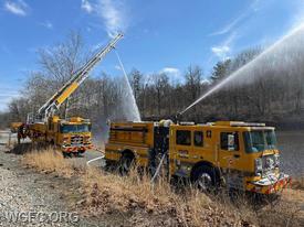 Engine 22-1 drafts water from the quarry, with high flow master streams operated from Ladder 22 and the Engine's truck-mounted deluge gun.