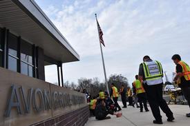 A full - scale drill involving police, fire, and EMS was conducted at the AG High School on Friday, with the WGFC shown here with other EMS partners attending to victims as officials observe the operations in front of the school.