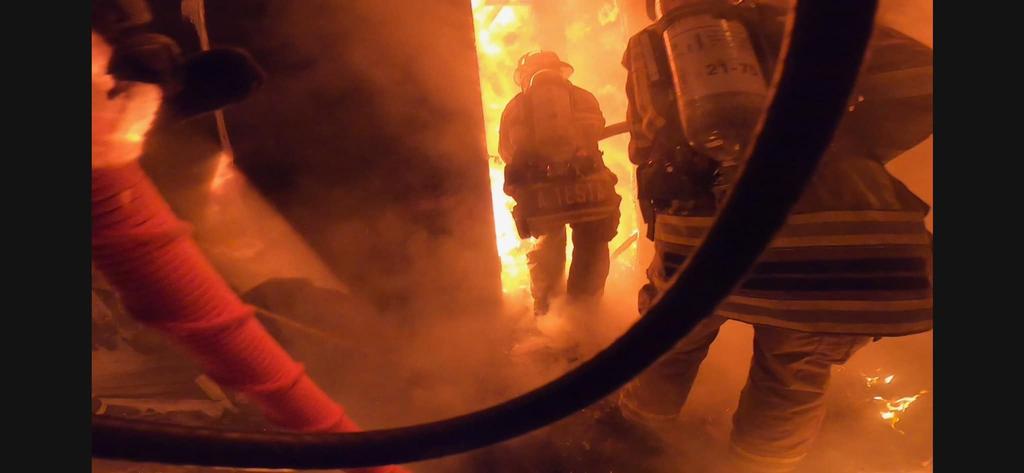 In this incredible photo, the first-in hose line crew from Oxford makes entry into the house with heavy fire conditions present.
