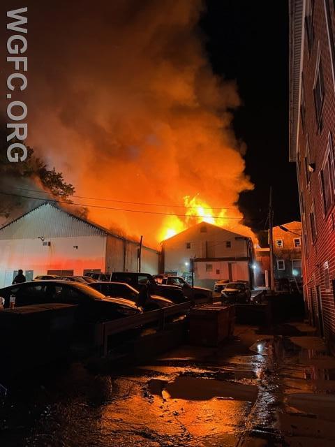 A warehouse behind apartment building on Oxford’s Third Street is fully involved as crews begin work at a 4-alarm fire on Thursday morning.
