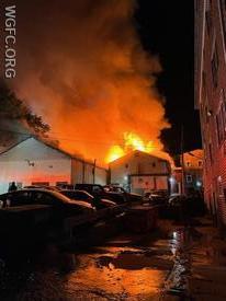A warehouse behind apartment building on Oxford’s Third Street is fully involved as crews begin work at a 4-alarm fire on Thursday morning.
