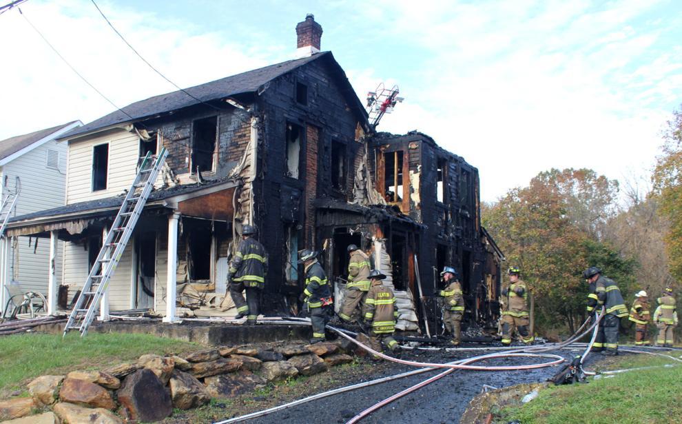 Firefighters mop up after this house fire (Photo Credit:  Cecil Whig).