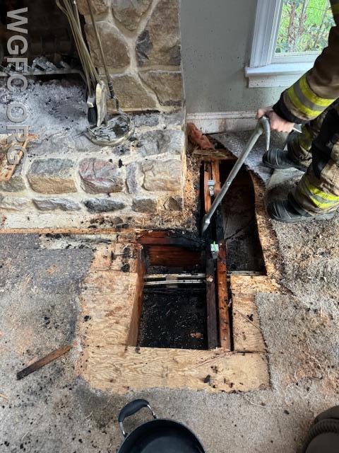 Crews used wedges and hand tools to separate floor joists to check for fire extension.