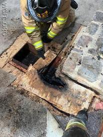 WGFC crews remove burned sections of flooring at this Franklin Township home.