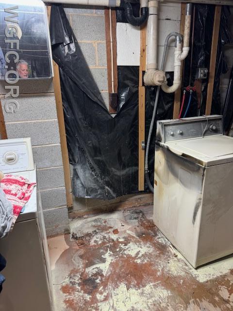 With the dryer removed, evidence of damage to the adjacent washing machine is visible, as is powder from the fire extinguisher used successfully by the homeowner to put the fire out prior to the WGFC's arrival.
