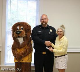 Deputy Chief Hawk accepts a donation on behalf of the fire company during the Avon Grove Lions Club's 2024-25 Distribution Night.