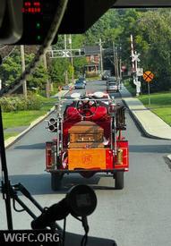 Past Chief W. Forrest Hammond takes his final ride aboard West Grove's Antique 22 during today's processional, as seen from Engine 22-2. 