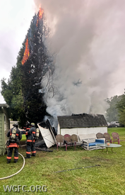WGFC firefighters deploy a handline to prevent a shed and tree fire from damaging a residence in London Grove Township.