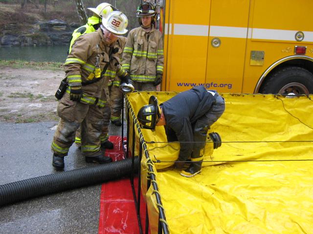 Henry sets up a standard hard sleeve hose through the drain of the tank.